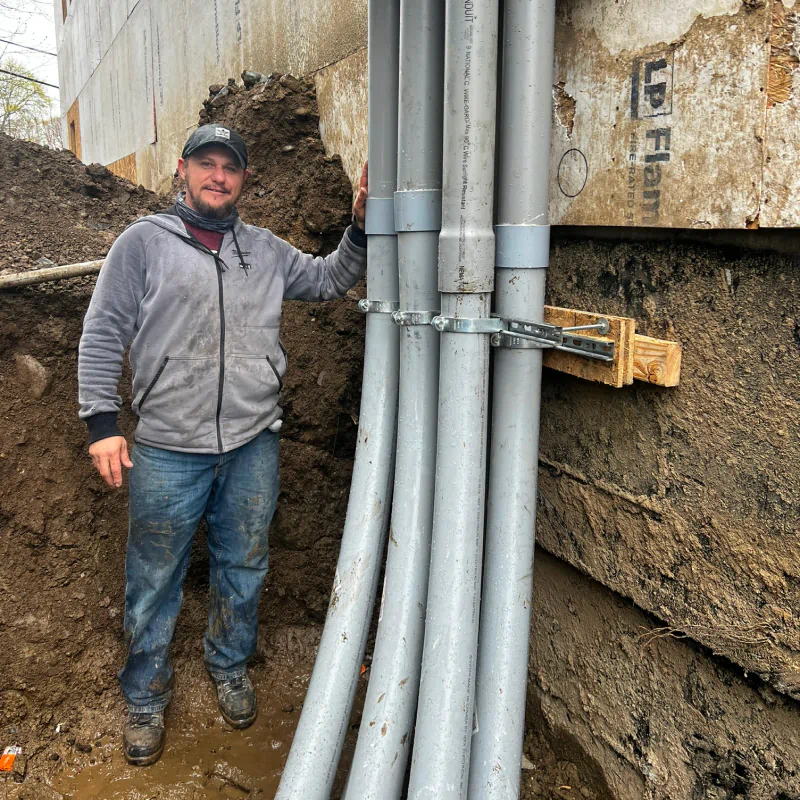 man holding huge electrical pipes